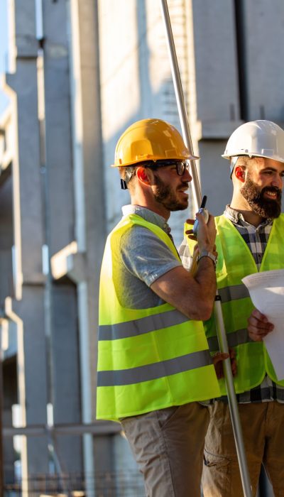 Construction engineers discussion with architects at construction or building site